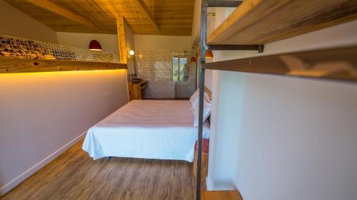 a bedroom with a bed in a small room at Eco-Apartaments Cal Rossa de Taús in Taús
