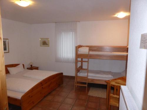 a bedroom with a bed and a bunk bed at Zum Kaiserwirt in Heppenheim an der Bergstrasse