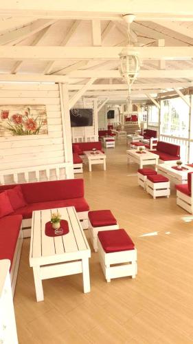a large room with couches and tables in a building at Hotel Kristal in Zlatograd