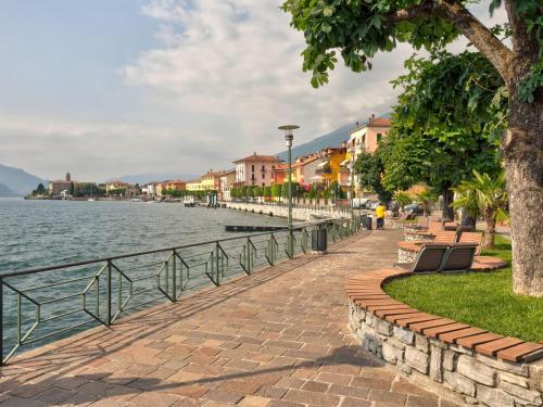 a sidewalk next to a body of water with buildings at Gravedona Lake Escape in Gravedona
