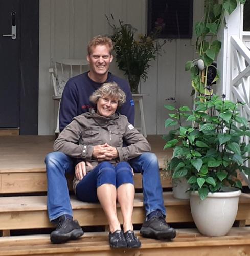 a man and a woman sitting on the steps at Villa Ekegården in Härryda