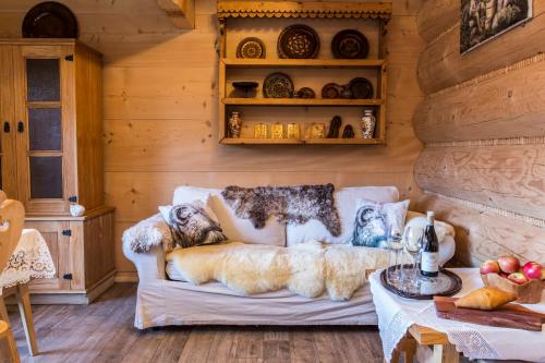 a woman laying on a couch in a room at Chaty Zakopane in Zakopane