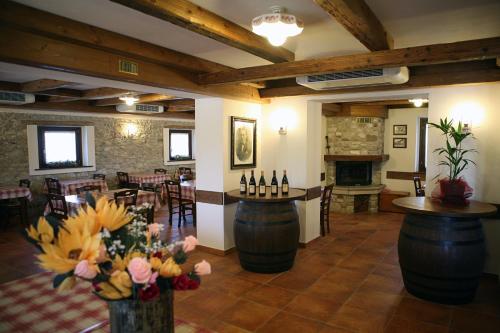 a wine tasting room with a bar and a dining room at Agriturismo La Rosta in Cervignano del Friuli