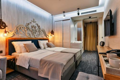 a hotel room with two beds and a sink at Boutique Hotel Tate By Aycon in Budva