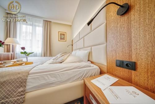 a hotel room with a bed and a desk at Hotel Wellness & Spa Nowy Dwór in Rzeszów