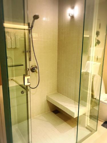 a bathroom with a shower with a glass shower backdoor at Veranda Residence Pattaya Nice Monthly rate available now in Na Jomtien