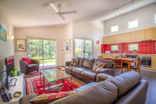 a living room with a couch and a table at Villa 28 Cape Villas in Dunsborough