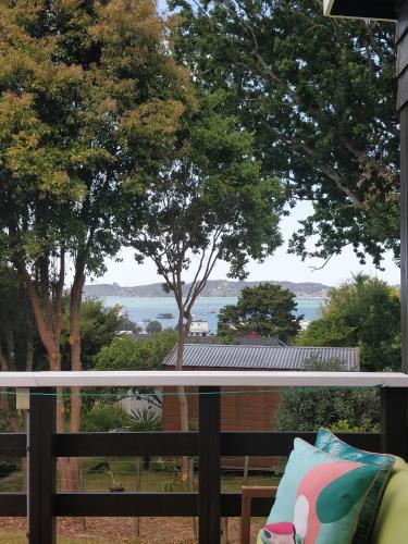 a balcony with a view of the water at Chalet Romantica in Paihia