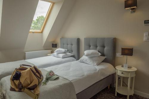 מיטה או מיטות בחדר ב-Noclegi Pod Sokołem