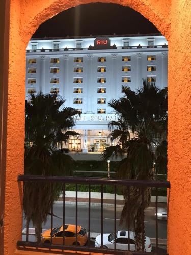 a view of a hotel with cars parked in front of it at Tu DEPA en el Paraíso Cancún 2 in Cancún