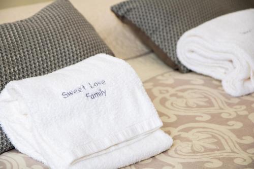 a towel that says sweet love family sitting on a couch at Sweet Love Family in Coimbra