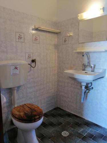 a bathroom with a toilet and a sink at Jason Rooms & Studios in Keratokampos