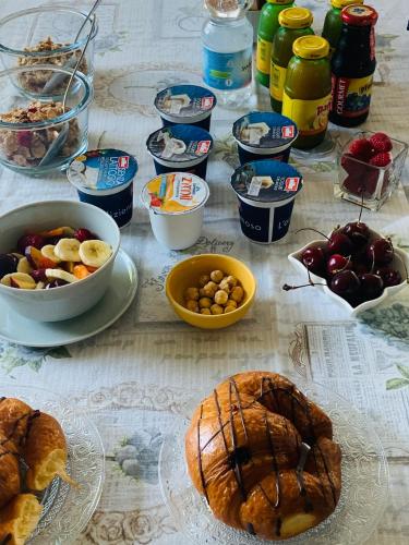 a table topped with bowls of food and other foods at B&B Beauty House in Cesena