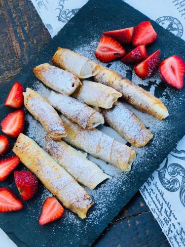 a black plate with strawberries on a table at Alanya Castle Apartment in Alanya