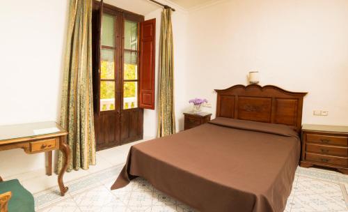Un pat sau paturi într-o cameră la Hotel España