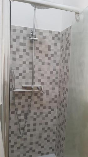 a bathroom with a shower with a glass door at un passo dal mare in Fiumicino