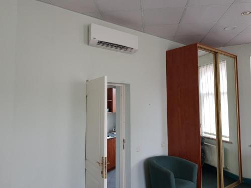 an office room with a ceiling fan and a chair at Avanta in Liepāja