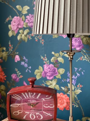 a clock in front of a wall with flowers at The Inn on the Moor Hotel in Goathland