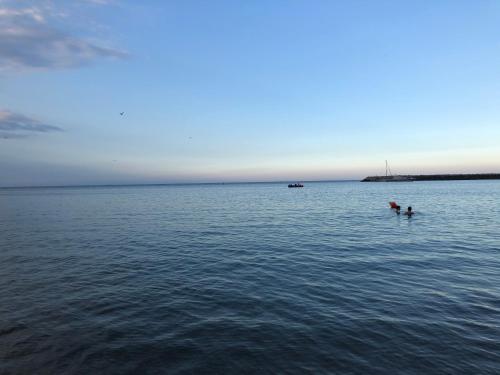 two people in the water in the ocean at Pensiunea Pont-Euxin in Constanţa