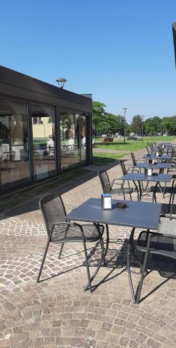 a row of tables and chairs in front of a building at Central in Casarile