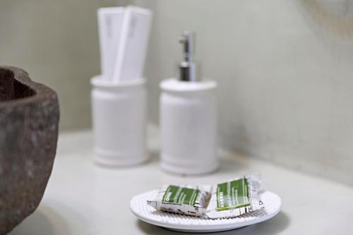 two toothbrushes on a plate on a bathroom counter at Helianthus Dream Homes in Oia