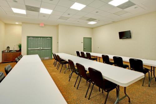 a conference room with white tables and chairs at Country Inn & Suites by Radisson, Tallahassee-University Area, FL in Tallahassee