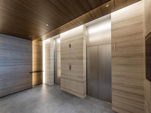 a walk in closet with wood paneled walls at Far East Village Hotel Tokyo Ariake in Tokyo