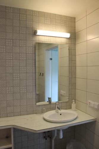 a bathroom with a sink and a mirror at Wanbo Herrgård in Nedre Vanbo
