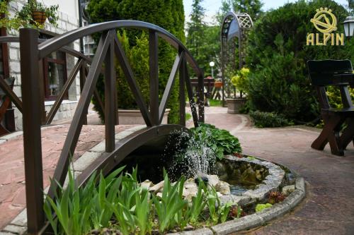 a small fountain in a garden with a water feature at Alpin Borovets, Алпин Боровец in Borovets