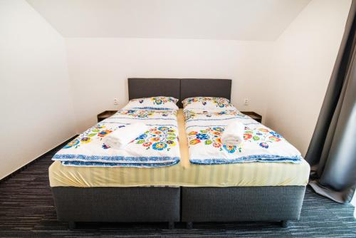 a bed in a room with two stuffed animals on it at Apartmany JA&MA in Liptovský Mikuláš