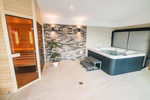 a bathroom with a bath tub in a room at Apartmany JA&MA in Liptovský Mikuláš