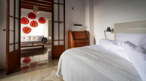 a bedroom with a white bed and a mirror at Es Picarol Sineu in Sineu