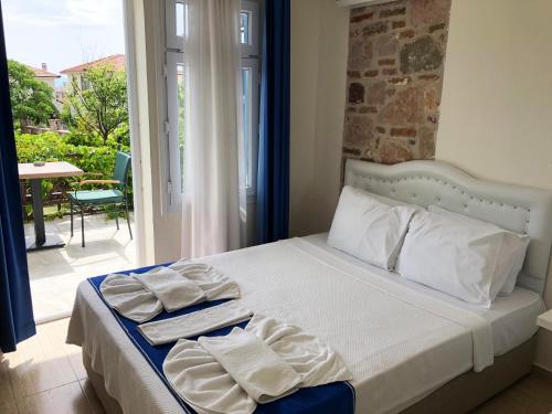 a bedroom with a bed with towels on it at Cunda La Vie in Balıkesir