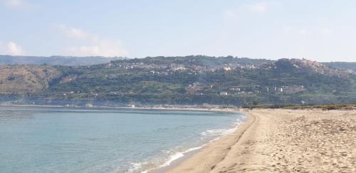 a view of a beach with houses on a hill at Casa del Sole in Nicotera Marina