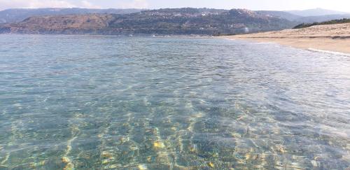 a large body of water with a sandy beach at Casa del Sole in Nicotera Marina