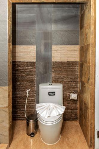a bathroom with a toilet with a bucket at Lanta Sport Resort in Ko Lanta