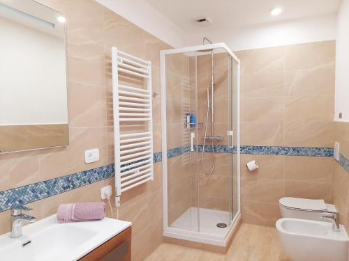 a bathroom with a shower and a sink and a toilet at Trieste Center Rooms & Apartments - Fiori di Trieste in Trieste