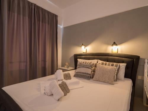 Ένα ή περισσότερα κρεβάτια σε δωμάτιο στο Pasiphae Hotel