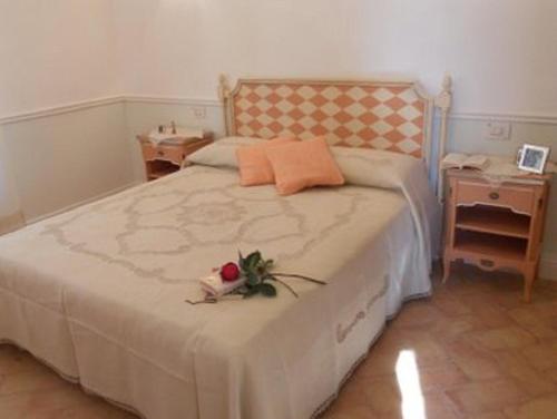 a bedroom with a large bed with a flower on it at Villa Liliana, Exclusive Property in Monte Rinaldo