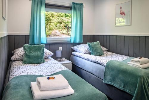 Postel nebo postele na pokoji v ubytování Domki pod klonem