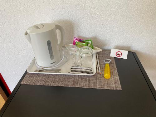 a tray with a blender on top of a table at Gasthaus Edelweiss in Langwies