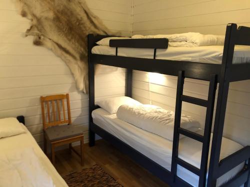 a room with two bunk beds and a chair at Sørlia hytte in Hafjell