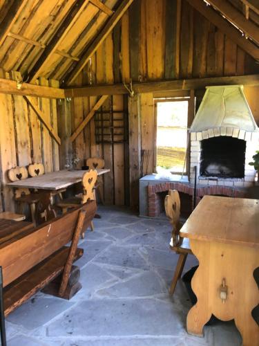 a room with tables and a bed in a barn at Biołe Izby in Chochołów