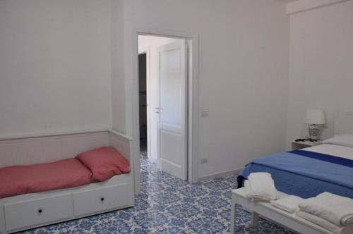 a bedroom with a bed and a mirror at Calise guest house B senza balcone in Procida