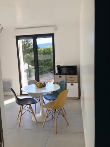 a white table and chairs in a kitchen with a window at Dans la Pouncho d’Agast in Millau