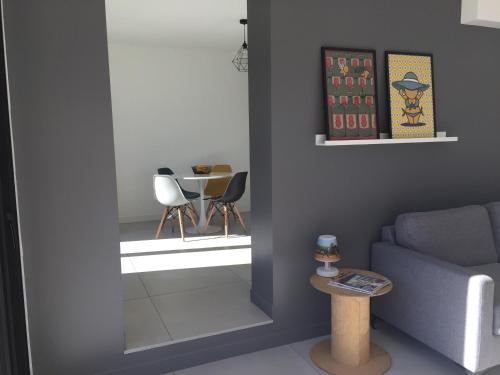 a living room with a blue couch and a table at Dans la Pouncho d’Agast in Millau