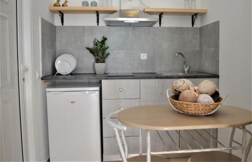 a kitchen with a table with a basket of mushrooms at Hotel Kastro in Skiathos Town