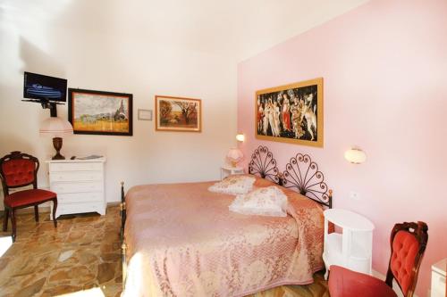 a bedroom with a large bed and a tv at Primettahouse in San Gimignano