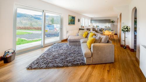 a living room with a couch and a rug at The GREENHOUSE in Aberfeldy