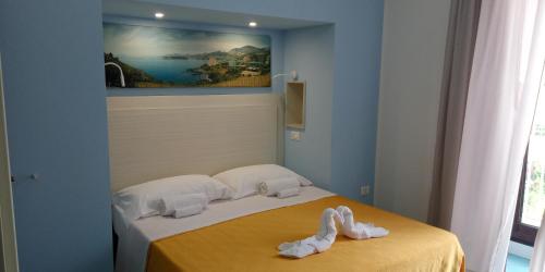 a bedroom with a bed with towels on it at Borgo 800 in San Nicola Arcella